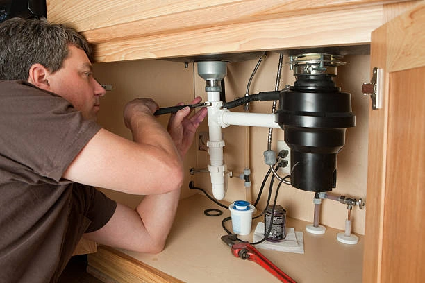 Technician installing tube fittings under a kitchen sink – tube fittings suppliers in Saudi Arabia
